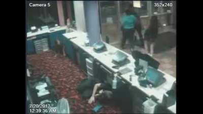 911 call from Keven Quinonez inside the Century 21 Theater in Aurora, CO while shooter James Holmes is firing, July 20, 2012. Added CCTV footage from the lobby.