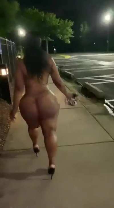 Bare naked in public except for stilettos showing off her massive bolted on ass