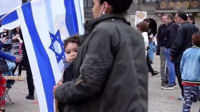 Mother makes her child spit on flag