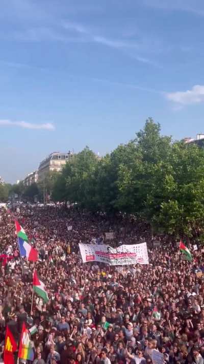 French protestors show support for Palestinians earlier this day Place de la République in Paris. They are singing 