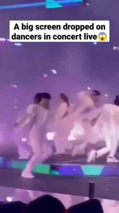 A big screen dropped on dancers in concert live.