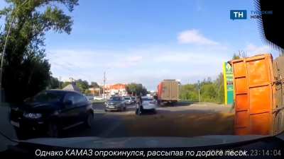 The truck driver lost control and overturned the truck.