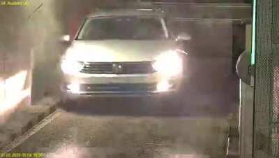 A car takes some hard knocks trying to enter a parking garage