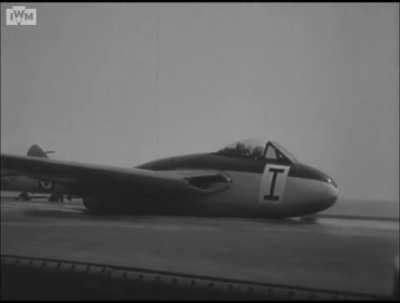 de Havilland Sea Vampire makes a wheels-up landing on a flexible deck installed on HMS Warrior in late 1948