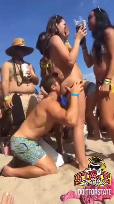 Eating her ass in a crowded public beach...crazy dude