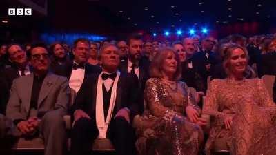 Youtube Prankster walks on stage with Chris Nolan and his Wife when Oppenheimer wins best film at BAFTA