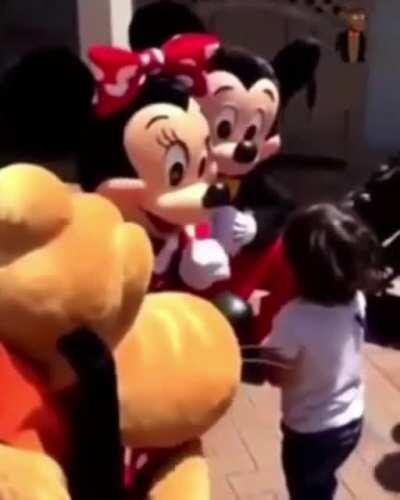 After Minnie realises this child is deaf, she communicates with him using ASL