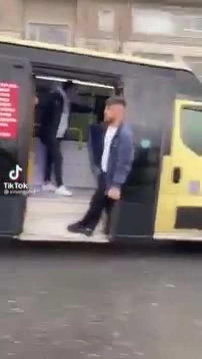 Hanging from the door of a bus