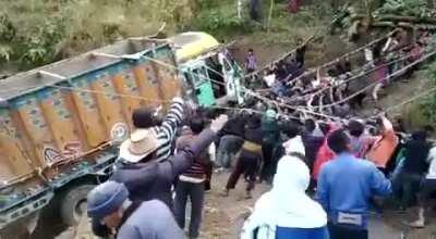 A group of people pull out a truck from a ditch in Nagaland