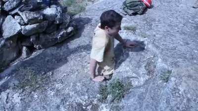 Guy passes through a small entry to explore a cave