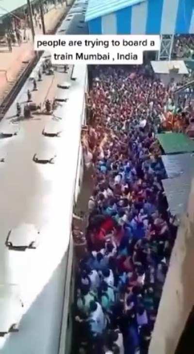 People trying to board a train in Mumbai India