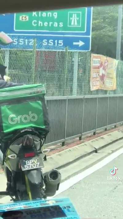 Abang grab saving kitten from harms way but took it with him at the end of the day