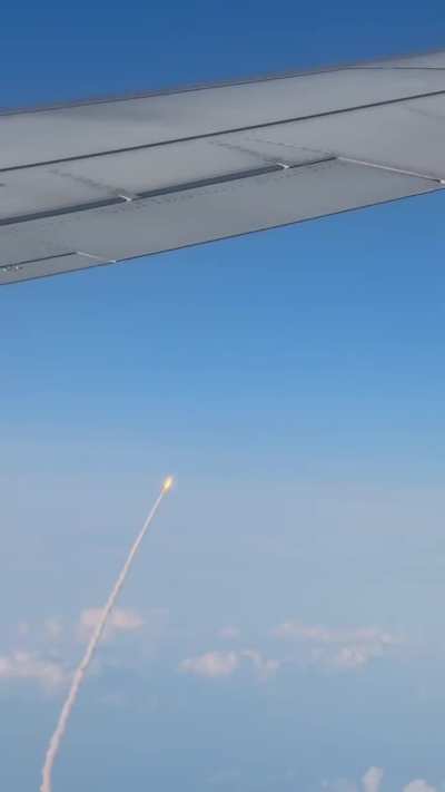 Humans flying over the Earth, while watching humans fly to the moon