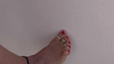 crushing a little spider with her big toe...love her red polish