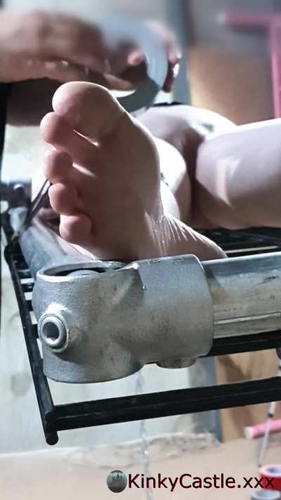 Duct taping her to a grid mesh and steel frame. Accidental artsy feet close up. [OC]