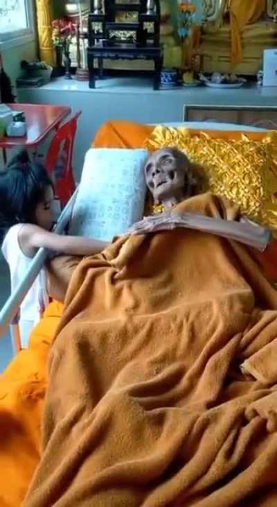100+ years old Thai Buddhist monk. Looks like a skeleton but is alive.