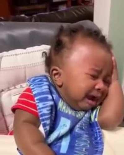 baby sees his father's new haircut