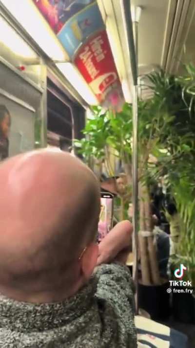 Guy hauls and loads his plants on the train 