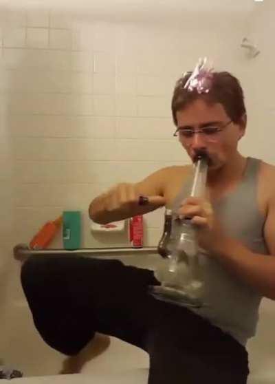 Guy lights head on fire, proceeds to hit a bong, poors out the bong to put out the flame with no reaction