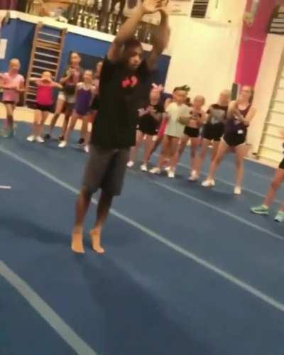 Teacher does a standing double backflip for the kids