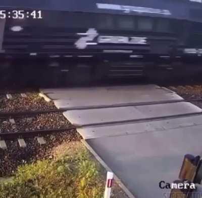 Car tries to beat train