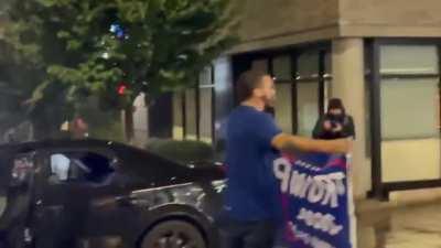 [War Crime] [1A Violation] Disguised as a reporter, liberal Antifa woman gets close to conservative Trumper and steals his flag. Source comment will show that that is a war crime.