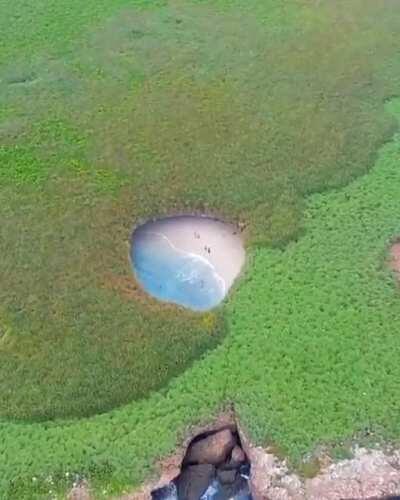 This is a hidden beach in the Merietas Islands, apparently it was created by a bomb because the islands were used by the military.