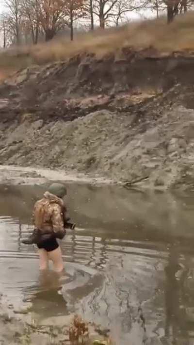 Ukrainian soldiers crossing a body of water in their undies - Got to keep those feet dry