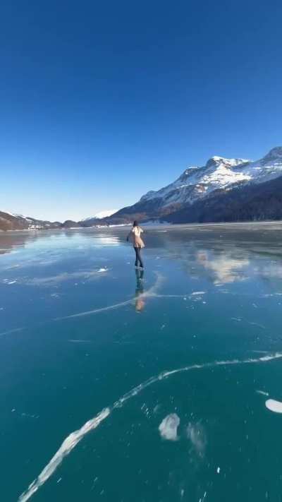 Figure skater on a frozen lake (source link in description)