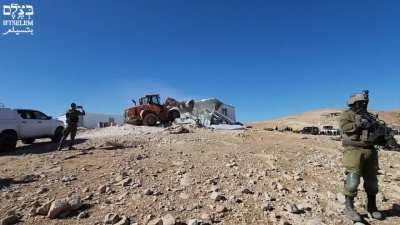 Demolition workers bring chairs and balloons to watch as Israel deletes a Palestinian school