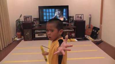 5 year old kid enacting Bruce Lee's epic nunchaku scene in Game of Death
