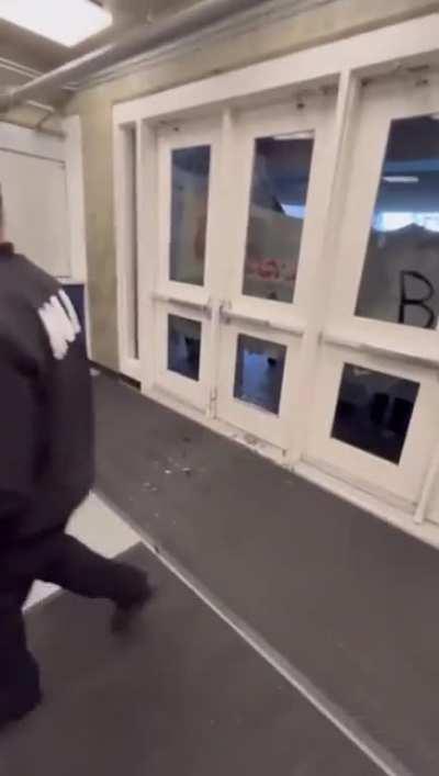 Protestors attempt to break into the University Credit Union Center during Charlie Kirk’s speech