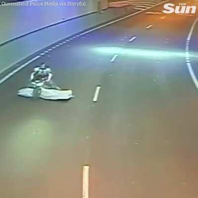 Motorcyclist has a soft landing after mattress falls off a truck