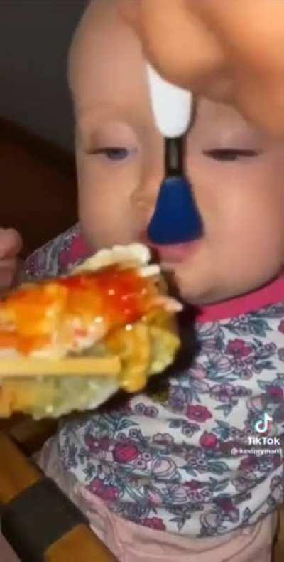 This baby thinks they're eating like a champion!