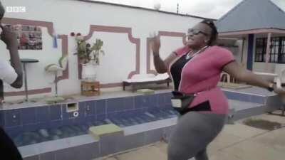 Jane Mugo showing her taekwondo-moves for a BBC reporter