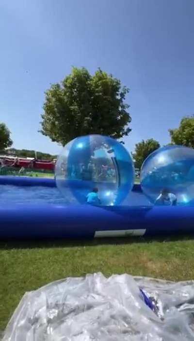Child playing in an inflatable ball