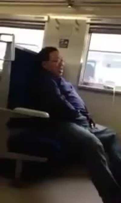 Man masturbating on a train under his pants, then maniacally smiles after licking his hands clean