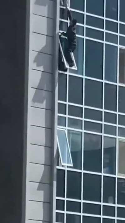 The man climbed out of his eighth floor apartment window to catch the helpless three-year-old girl.