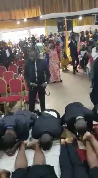 Pastor flogging the demons out