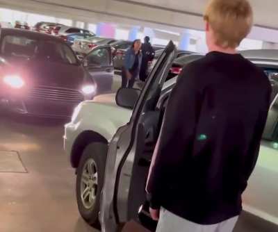 Woman goes against one way traffic in a parking garage, then demands that guy in front of her goes around 