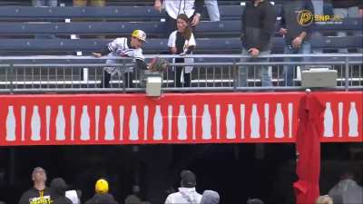 An MLB player tosses a ball to a kid wearing his jersey. The kid makes the catch, then hands it to his little sister and gives her a hug