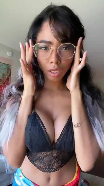 Adjusting her glasses