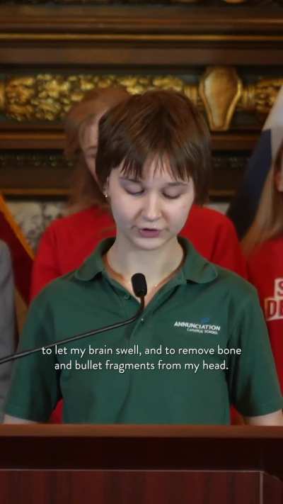 Lydia Kaiser, an 8th-grade survivor of gun violence, stands up on the stage with Tim Walz and states:  “116 bullets through the stained-glass windows. 2 students shot and killed. 2 survived gunshots injuries to the head. I am one of them… elected official