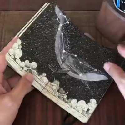 An artist showing off their sketchbook
