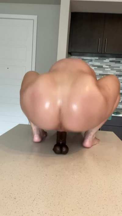 Black dildos make her squirt all over the counter