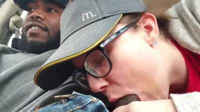 Female employee giving a quick suck in car to a black client