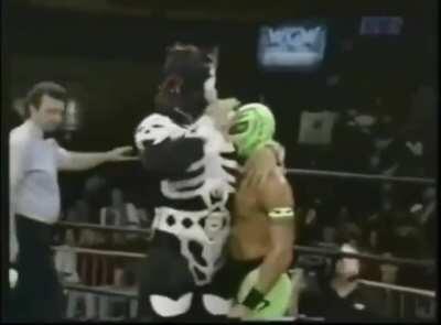 La Parka celebrates after an absolutely devastating headlock on Rey Mysterio