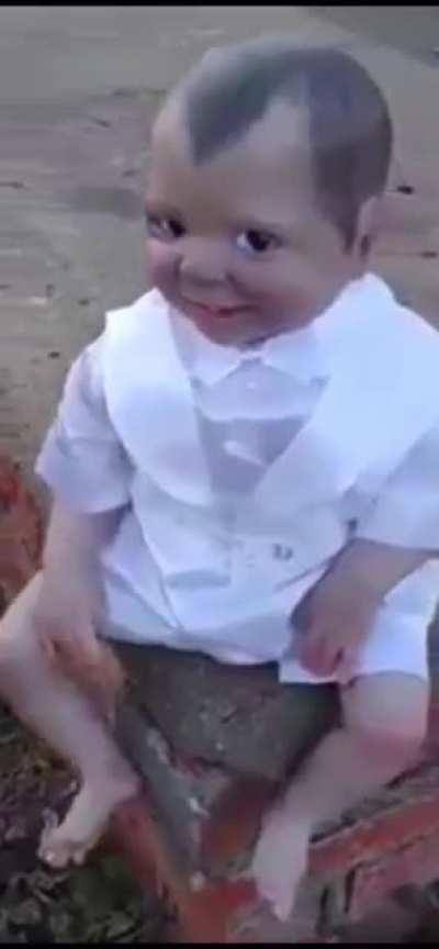 A doll chillin in a graveyard