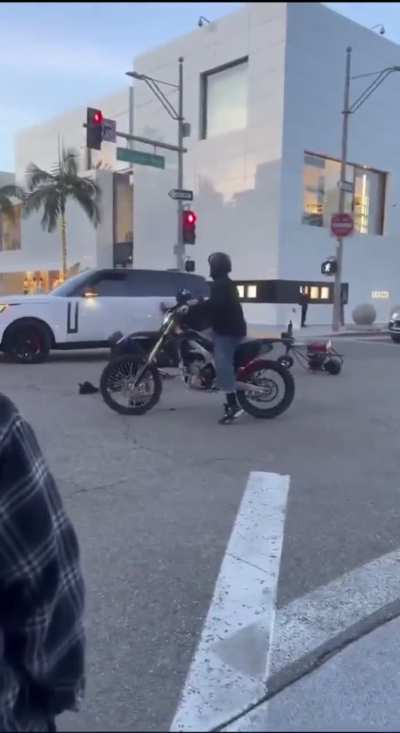 Biker gang tries to run red light, immediately finds out