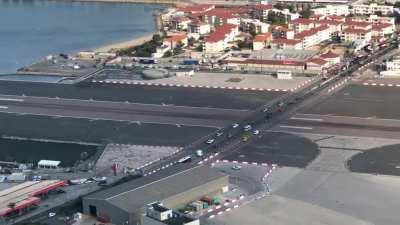 High way running right through the tarmac of an airport.